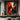 "Shadow & Spark" abstract oil painting featuring a dynamic interplay of deep blacks and greys with vibrant, textured accents of yellow, orange, and red.
