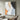 Minimalist abstract painting with beige, black, and soft blue textures on canvas