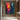 abstract expressionist oil painting of silhouette figure between red and blue city lights, modern vertical canvas with emotional color contrast