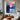 "Vertical Radiance" abstract painting featuring a vibrant interplay of pink and blue hues with a central luminous effect and dynamic, textured brushwork.
