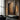 Textured impasto oil painting with layered charcoal black and sienna brown earth tones, raw brushstrokes revealing ochre and white pigment undertones.